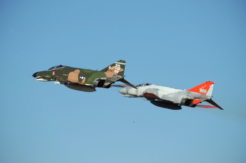 GD DSC_4286.JPG - Two QF-4E Phantom IIs fly in formation after making a low-approach to the runway at Tyndall AFB, FL. on 17 Nov. 2008. Both aircraft are assigned to the 82nd Aerial Targets Squadron (ATRS), 53rd Weapons Evaluation Group (WEG) at Tyndall AFB, FL. The closest aircraft is QF-4E, serial # 72-1478. This aircraft participates in the popular USAF 'Heritage Flight' program and wears a magnificent Southeast Asia paintscheme, full colored sharksmouth and tail markings for the Commander of the 82nd ATRS. The jet is being piloted by the 82nd ATRS Commander, LtC. JD 'Bare' Lee. The second aircraft is QF-4E, serial # 74-1043 and is being piloted by Mr. Tom 'Packer' Mudge. 74-1043 wears unusual two-tone grey marking from its last unit of the 906th Fighter Wing, 704th Fighter Squadron based at Bergstrom AFB, TX. Only a few aircraft assigned to this particular unit were painted in this scheme. Both aircraft hav been returned to service after being modified into drones by BAE Systems in Mojave, CA. The jets continues to serve the AF's needs as full-scale aerial targets and will eventually be destroyed by missiles etc. while being flown by a remote operator on the ground. Photographed on 17 Nov. 2008.  © 2008 Greg L. Davis, Aviation Photojournalist  www.focalplaneimagery.com
